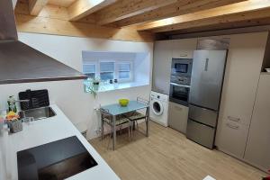 a kitchen with a table and a counter top at Villa de Cueto in Santander