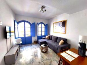 a living room with a couch and a table at More Center Apartment in Seville