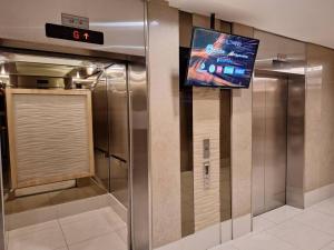a television on the wall of a elevator at Best staycation at Shell residences in MOA complex in Manila