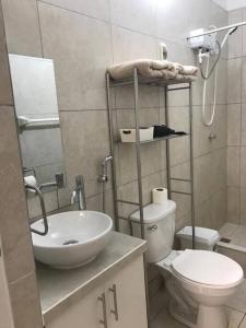 a small bathroom with a sink and a toilet at Albano: Habitación completa acústica in Chosica