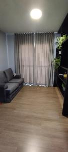 a living room with a couch in front of a window at Flat Santa Cruz do Sul III in Santa Cruz do Sul