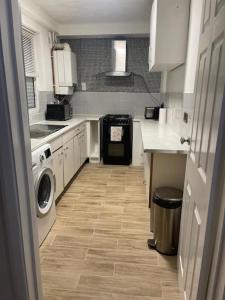 a kitchen with a washer and dryer in it at Tms 3bdr Tilbury - Free Parking in Tilbury