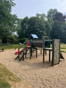 a playground with a slide in a park at Château de Porcheresse in Daverdisse