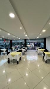 una sala da pranzo con tavoli e sedie in un edificio di Hotel Gran Conquistador 33 a Medellín