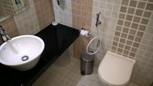 a bathroom with a sink and a toilet at Sitaram Mountain Retreat in Munnar