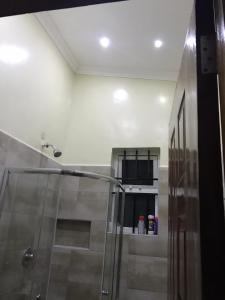 a bathroom with a shower with a glass shower stall at Pendeza La Casa in Naivasha