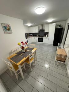 a kitchen with a table and chairs and a dining room at Comfort Zone in Colchester
