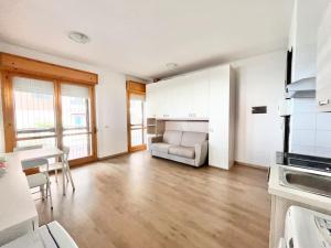 a kitchen and living room with a couch and a table at Brunori Home in Rome