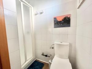 a white bathroom with a toilet and a window at Brunori Home in Rome