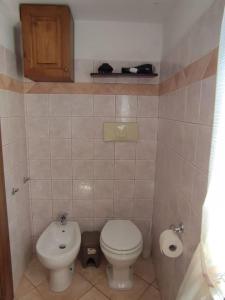 a small bathroom with a toilet and a sink at La Casetta in Porto Santo Stefano +8 photos