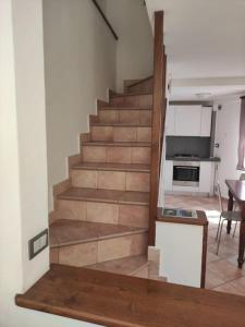 a staircase in a living room with a kitchen at La Casetta in Porto Santo Stefano