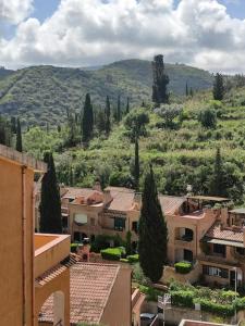 a view of a village with trees and buildings at La Casetta in Porto Santo Stefano