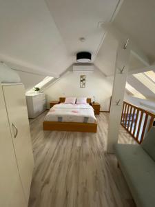 a bedroom with a bed in the middle of a room at Appartement Lijnden in Lijnden
