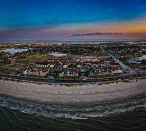 an aerial view of a city with houses and water at Oceanfront at The Dawns in Galveston