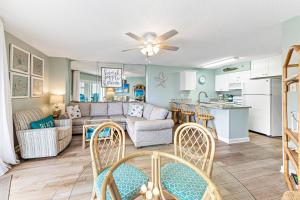 a living room and kitchen with a couch and a table at Tradewinds Unit 608 in Orange Beach