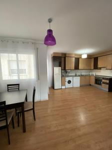 an empty living room with a table and a kitchen at Apartamento Sant Blai in Tivissa +12 photos