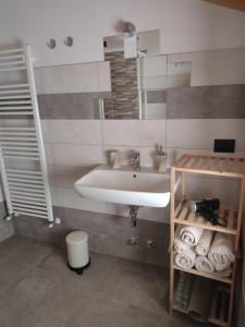 a bathroom with a sink and a mirror at B&B Vivi l'Attimo in Campodenno +14 photos