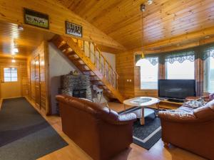 a living room with couches and a fireplace in a log cabin at Holiday Home Pepi by Interhome 