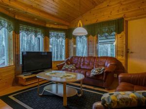 a living room with a leather couch and a tv at Holiday Home Pepi by Interhome 