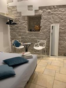 a bedroom with a bed and a table and chairs at Il Moretto in Trani