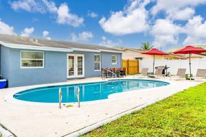 - une piscine en face d'une maison dans l'établissement Tropical Oasis Miami Pool Haven, à Miami Gardens