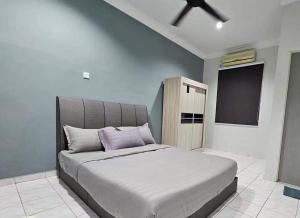 a bedroom with a large bed with a flat screen tv at Tambun Sunway Homestay in Tambun