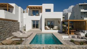 a villa with a swimming pool and a house at Fyrōi Naxos in Agia Anna Naxos