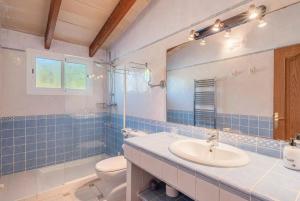 a bathroom with a sink and a toilet and a mirror at Es Rafal in Santa Margalida +23 photos