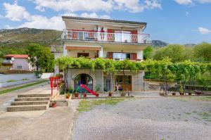 a house with a playground in front of it at Apartment Ivona in Tribalj