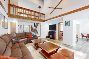 a living room with a couch and a table at Blue Skies & Bay Bliss in Carnelian Bay