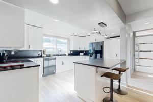 a kitchen with white cabinets and a black counter top at Hillside Sanctuary in Portland
