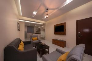 un soggiorno con 2 divani e una TV di Diaara Hotel Appartments a Khamis Mushayt