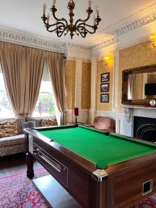 a living room with a pool table and a chandelier at The Mountford Hotel - Free Parking in Liverpool