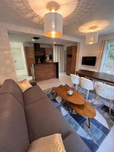 a living room with a couch and a table at Domaine des rives d'Ormoy - Athamante in Ormoy-la-Rivière