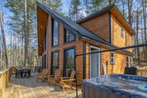 a log cabin with a hot tub on a deck at Private Cabin w King Bed and Private Hot Tub in Rogers