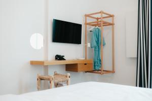 a bedroom with a tv and a chair and a mirror at Shada Hotel - فندق شدا in Dubai