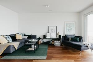 a living room with a couch and a table at Apartment Fortaleza in Amden