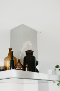 a shelf with bottles on it in a kitchen at Apartment Fortaleza in Amden