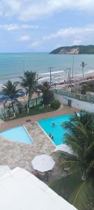an overhead view of two swimming pools next to a beach at Beira-Mar flat 310 Ponta Negra Beach in Natal