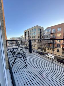 a balcony with a chair sitting on a deck at Flexhome Third Ward 1BR J2 with Gym and Balcony - READ INFO in Milwaukee