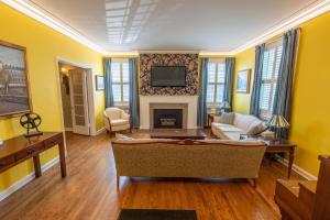 a living room with a couch and a fireplace at Cardinal Inn Romantic Room in Cornwall