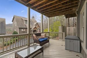 a woman sitting in a chair on a porch at The Laurel Ridge Den in Big Canoe with hot tub in Marblehill