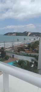 a view of a beach and the ocean from a balcony at Beira-Mar flat 310 Ponta Negra Beach in Natal