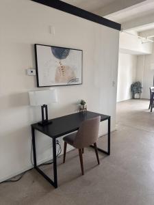 a desk with a chair and a lamp in a room at Flexhome Westown 1BR RS2 near Fiserv and Theater District - READ INFO in Milwaukee
