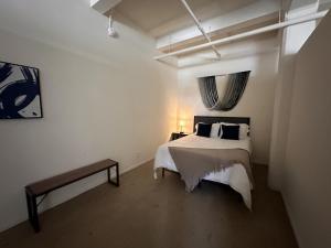 a bedroom with a white bed and a window at Flexhome Westown 1BR RS2 near Fiserv and Theater District - READ INFO in Milwaukee