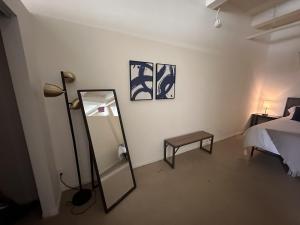 a room with a mirror and a bed and a lamp at Flexhome Westown 1BR RS2 near Fiserv and Theater District - READ INFO in Milwaukee