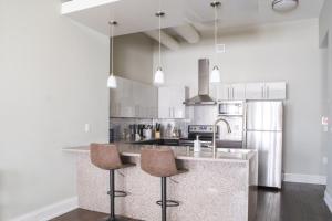 a kitchen with a counter with two bar stools at Flexhome East Town 1BR MF3 - READ INFO in Milwaukee