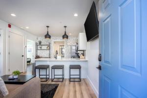 a kitchen and living room with a blue door at Stylish Condo in Hillsboro Village 3 Beds and Parking in Nashville