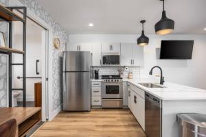 a kitchen with white cabinets and stainless steel appliances at Stylish Condo in Hillsboro Village 3 Beds and Parking in Nashville