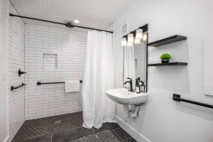 a white bathroom with a sink and a shower at Stylish Condo in Hillsboro Village 3 Beds and Parking in Nashville +57 photos